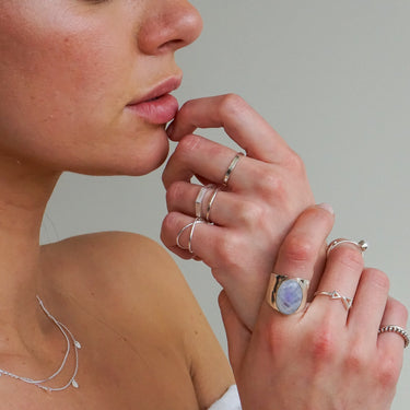 Model wearing adjustable sterling silver bohemian rings with moonstone statement ring